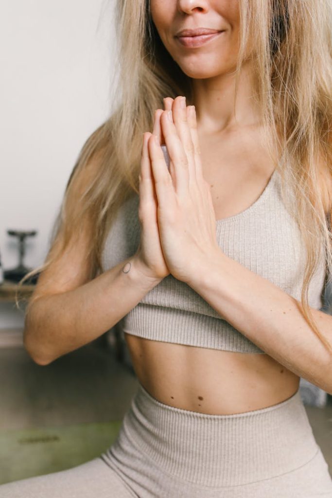 Woman in Beige Crop Tank Top Sitting in Yoga Position Meditating